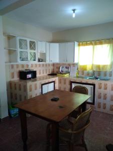 Ker BakaryHarmony house apartments的厨房配有木桌和椅子