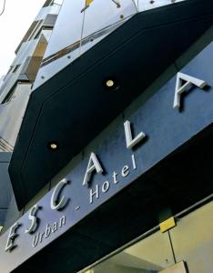 齐克拉约Hotel Escala的建筑一侧的酒店标志