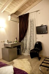 纳夫普利翁格里马尼旅馆的客房设有床、椅子和窗户。