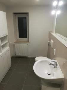 VeldenFerienhaus Kurzbach的白色的浴室设有水槽和窗户。