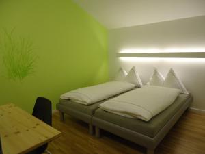 Härkingen阿尔特嘉尔特内瑞酒店的绿色客房 - 带枕头的床