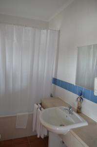 CajadosAldeamento Turístico de Palmela的白色的浴室设有水槽和淋浴。