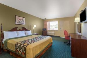 达拉姆速8达勒姆酒店的酒店客房配有一张床、一张书桌和一台电视。