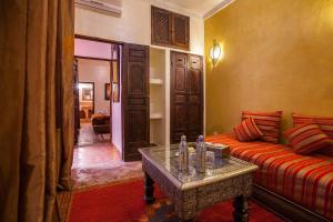 马拉喀什阿莱卡摩洛哥传统庭院住宅的客厅配有沙发和桌子