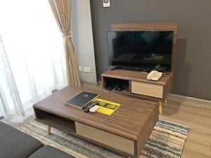 瓜埠海景公寓酒店的客厅配有咖啡桌和平面电视。