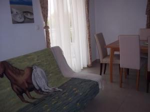 沃迪切Vila Ivančica 2的客厅配有一张沙发,上面有一幅马画