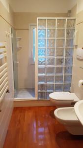 拉帕洛Villa Olimpo的浴室设有2个卫生间和玻璃淋浴间。