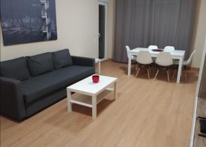 萨莫拉Zamora Apartments的客厅配有沙发和桌子