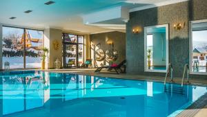 扎科帕内Hotel Paryski Art & Business Zakopane - Basen Jacuzzi Sauna Małpi Gaj的一座蓝色的游泳池