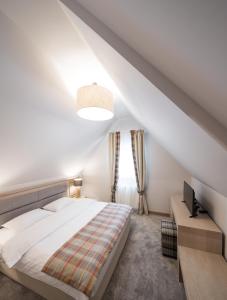 莫罗埃尼Chalet Alpina的白色的卧室设有床和窗户