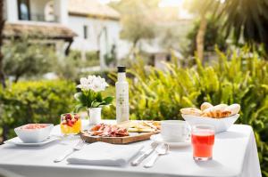 马贝拉马贝拉俱乐部高尔夫水疗度假酒店的一张桌子,上面放着一盘食物和一瓶葡萄酒