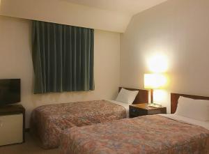 熊谷熊谷马罗德酒店的酒店客房设有两张床和电视。
