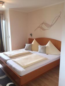 因戈尔施塔特瓦格纳宾馆 的一张位于房间的床,上面有两个枕头