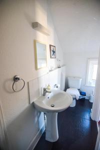 伊斯特布恩伊斯特布恩莱美酒店的白色的浴室设有水槽和卫生间。