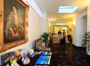 洛迦诺Hotel Rio Muralto的墙上有画的房间,人们站在房间里