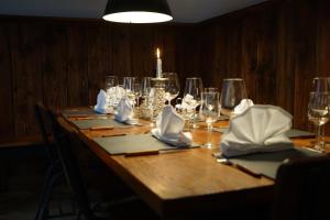 迪森阿姆阿梅尔塞Mara Restaurant & Hotel的一张带酒杯的木桌和蜡烛