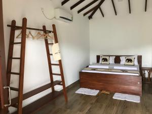 锡吉里亚Into The Wild Sigiriya的一间卧室配有一张双层床和梯子