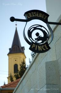 托考伊Erzsébet Pince的挂在砖墙边的标志