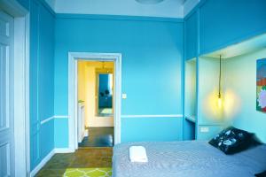 华沙4th Floor Bed and Breakfast的蓝色的客房配有床和镜子