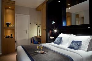 巴黎玛索香榭丽舍酒店的一间酒店客房,配有一张带酒杯托盘的床