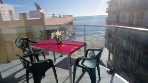 瓜尔达马尔·德尔·塞古拉Apartamentos Marjal 3的阳台上的红色桌子和椅子