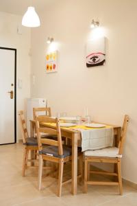 雅典Cozy Bright Apartment的一间带木桌和椅子的用餐室