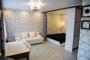 秋明Апартаменты на Луначарского的客厅配有沙发和1张床