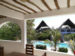 吉汶瓦Breeze Residence Apartments的从度假村的用餐室可欣赏到游泳池的景色