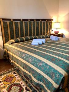 米兰卡希纳加吉利旅馆的一间卧室配有一张带绿色和白色毯子的床