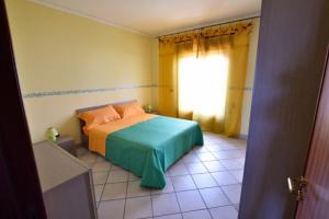梅利萨诺Appartamento Orchidea的一间卧室设有一张床和一个窗口