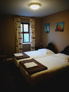 Kells凯丁斯酒店的配有窗户的酒店客房内的两张床
