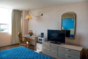 托卢卡旧金山酒店的一间酒店客房,配有一张床、一台电视和一面镜子
