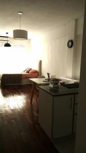 布宜诺斯艾利斯M & C Suites的客厅配有一张床和一张桌子