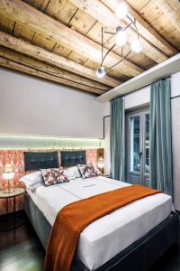 米兰洛坎达潘德努斯布雷拉住宿加早餐旅馆的一间卧室设有一张带木制天花板的大床