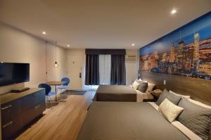拉瓦尔法布里维勒汽车旅馆&套房的酒店客房设有两张床和一台平面电视。