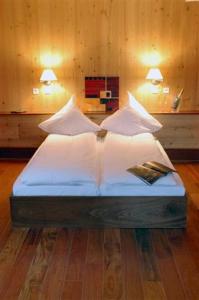 Philippsbourg弗肯酒店的一间卧室配有带白色床单和枕头的床。