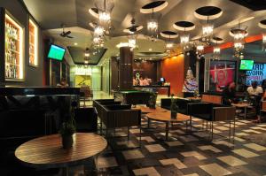 芭东海滩铂金公寓及酒店的一间带桌椅的餐厅和一间酒吧