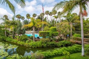 圣巴巴拉圣巴巴拉华美达酒店的棕榈树花园中的游泳池