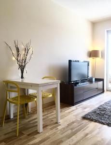 华沙ClickTheFlat Artistic Estate Apartment的客厅配有白色桌子和电视