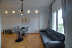 雅典Apartment in Glyfada Center的客厅配有沙发和桌子