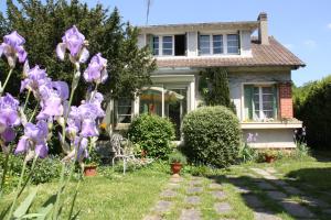 伊薇特河畔比尔B&B Le Cottage Paris Saclay的院子里鲜花盛开的房子
