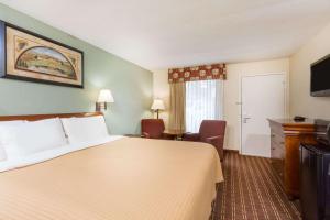 奥兰治堡Days Inn by Wyndham Orangeburg的酒店客房设有一张大床和一台电视。