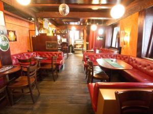 苏黎世格雷戈里酒店的一间设有红色皮革座椅和桌子的餐厅