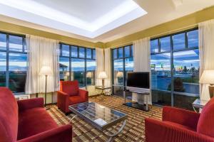 温莎洛克斯布拉德利机场戴斯酒店的客厅设有红色家具和大窗户