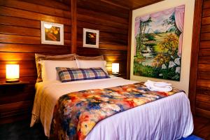 佩德拉阿祖尔奥格尼卡庄园旅馆的卧室配有一张床,墙上挂有绘画作品