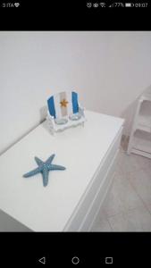 莫诺波利Casa Vacanza La Conchiglia的一张带海星的白色桌子和一把椅子