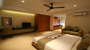 蔻立Khaolak Blue Lagoon Resort - SHA Extra Plus的酒店客房配有一张床和吊扇。
