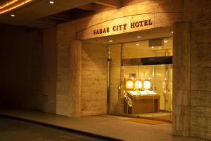 SabaeSabae City Hotel的商店前方有读萨克市酒店的标志
