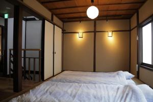 京都邵恩塞度假屋的墙上有两盏灯的房间的一张床位