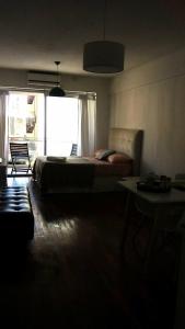 布宜诺斯艾利斯M & C Suites的一间卧室设有一张床和一个大窗户